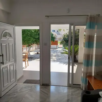 an open door with a view of a patio at ALEX FRUIT TREE HOME in Voroklini