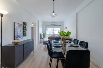 a dining room and living room with a table and chairs at Citrus 3-Bedroom Apartment in Larnaca in Larnaka