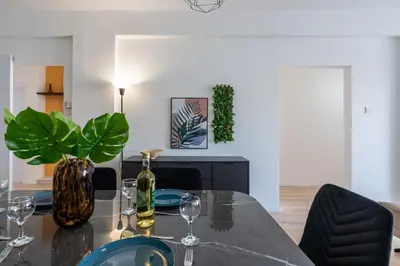 a dining room with a glass table and chairs at Citrus 3-Bedroom Apartment in Larnaca in Larnaka