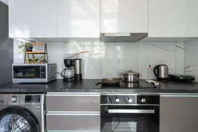 a kitchen with a stove and a microwave at Artemis 1-Bedroom Apartment in Larnaca in Larnaka
