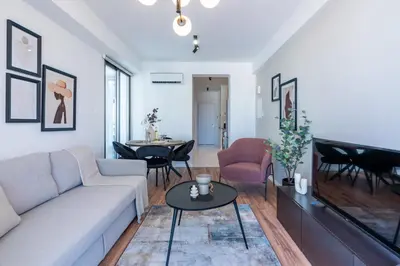 a living room with a couch and a table at Vanilla's Prime 1-Bedroom Apartment in Larnaca in Larnaka