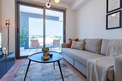 a living room with a couch and a table at Vanilla's Prime 1-Bedroom Apartment in Larnaca in Larnaka