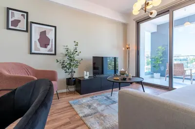a living room with a couch and a table at Vanilla's Prime 1-Bedroom Apartment in Larnaca in Larnaka