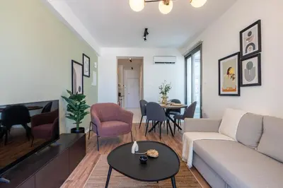 a living room with a couch and a table at Latte's Prime 1-Bedroom Apartment in Larnaca in Larnaka