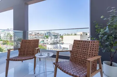 two chairs and a table on a balcony at Latte's Prime 1-Bedroom Apartment in Larnaca in Larnaka
