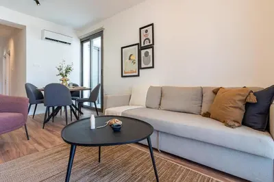 a living room with a couch and a table at Latte's Prime 1-Bedroom Apartment in Larnaca in Larnaka