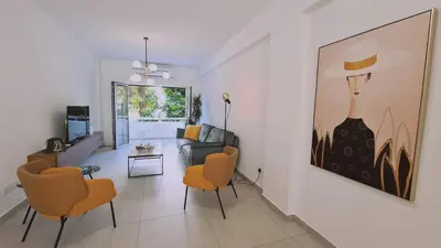 a living room with chairs and a painting on the wall at STAY Vital Elegance in Limassol