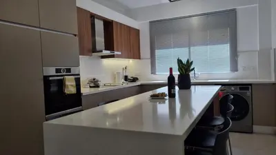 a kitchen with a counter with a bottle of wine on it at STAY Vital Elegance in Limassol