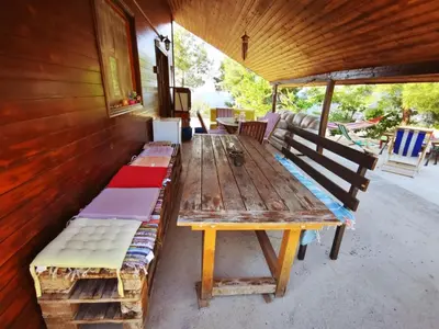 a long wooden table and benches in a building at The Mouflon House Pedoulas in Nicosia