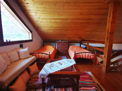 a living room with a couch and chairs in a cabin at The Mouflon House Pedoulas in Nicosia