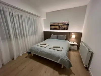 a bedroom with a bed with two towels on it at Daniela's modern apartment in Strovolos