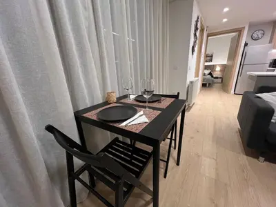 a dining room table with wine glasses on top of it at Daniela's modern apartment in Strovolos