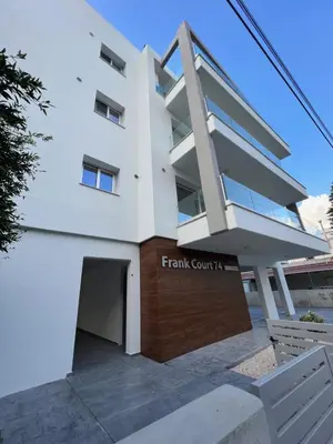 a large white building with a garage at Natali's luxury apartment in Strovolos