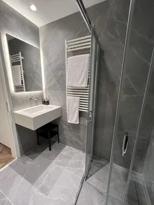 a bathroom with a sink and a shower at Natali's luxury apartment in Strovolos