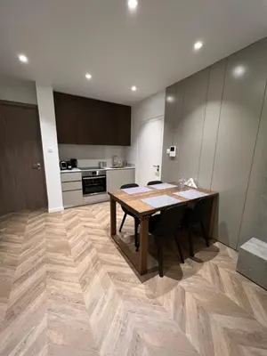 a kitchen with a wooden table in a room at Natali's luxury apartment in Strovolos