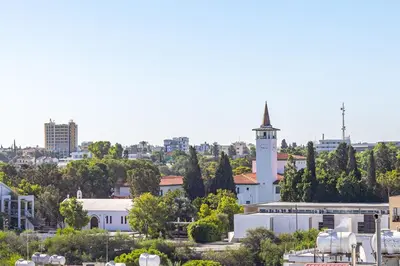 a city skyline with a white building and a tower at Cosy Apart at Lykavitos in Nicosia