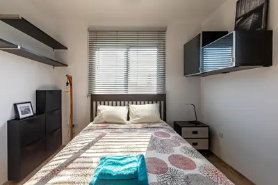 a bedroom with a bed and a window at Cosy Apart at Lykavitos in Nicosia