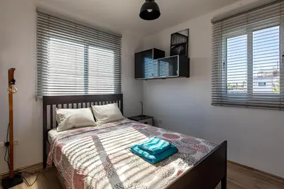 a bedroom with a bed with a blue bag on it at Cosy Apart at Lykavitos in Nicosia