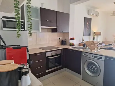 a kitchen with a washing machine and a dishwasher at Paramount Gardens Resorts D204 in Tersephanou