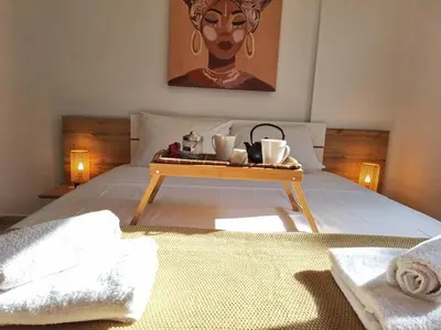 a tray with two coffee cups on a bed at Paramount Gardens Resorts D204 in Tersephanou