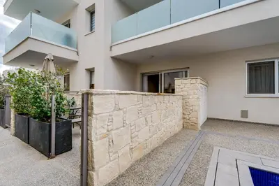 a stone retaining wall in front of a house at Anchora in Paralimni