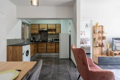 a kitchen and dining room with a table and chairs at Powder’s 1-Bedroom Retreat in Mackenzy, Larnaca in Larnaka