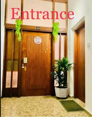 an entrance to an office with a wooden door at Past or Tail hostel in Larnaka