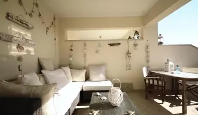 a living room with a couch and a table at Welcome to Thea Court in Paralimni