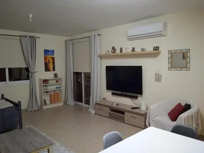 a living room with a flat screen tv on the wall at Xylophagou Rest and Relax 3 Ayia Napa Larnaca 1 bedroom apartment in Xylophaghou