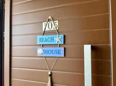 a house door with a sign that reads beach chef house at Larnaca BeachHouse in Larnaka