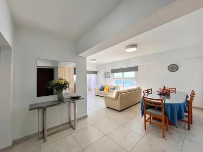 a living room with a table and a couch at Larnaca BeachHouse in Larnaka