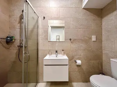 a bathroom with a shower and a sink and a toilet at Larnaca BeachHouse in Larnaka
