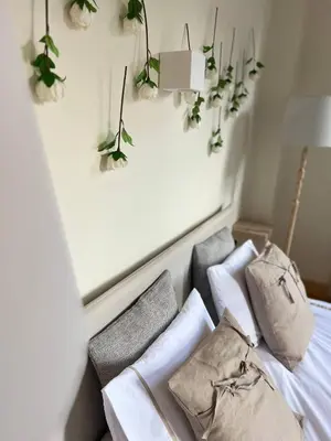a room with a bed with flowers on the wall at Nicosia City Centre Luxury Renovated Apartment in Nicosia