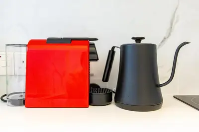 a red and black appliance sitting on a counter at City Center Apartment in Nicosia