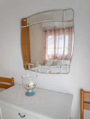 a glass bowl on top of a dresser with a mirror at Sun & Sand Private Villa in Protaras
