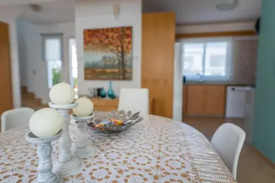 a dining room table with white eggs on top of it at Sun & Sand Private Villa in Protaras