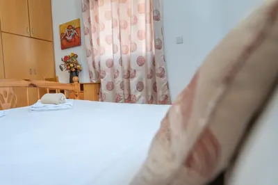 a bedroom with a white bed with a curtain at Sun & Sand Private Villa in Protaras