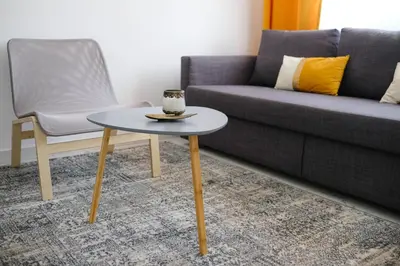a coffee table in a living room next to a couch at Lima Residence in Nicosia