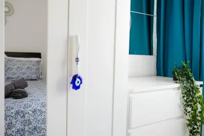 a room with blue curtains and a white door at Lima Residence in Nicosia