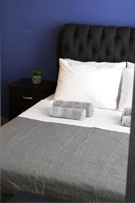 a white bed with two pillows on top of it at Raise Limassol Urban Escape in Limassol
