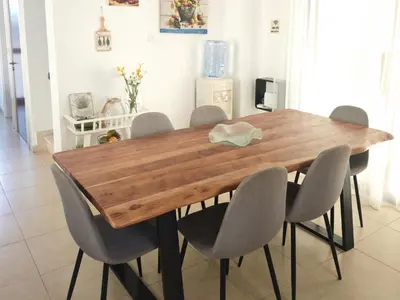 a dining room table with gray chairs around it at Fotini Villas in Protaras