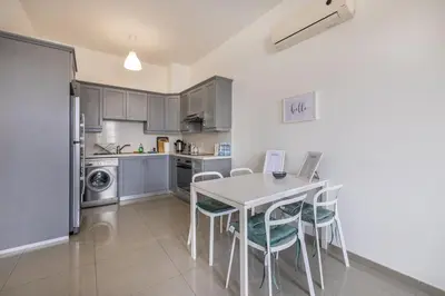 a kitchen with a table and chairs in a room at Pageant Homes in Nicosia