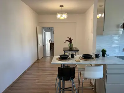a kitchen with a table and chairs in a room at Sunny Rooms in Limassol