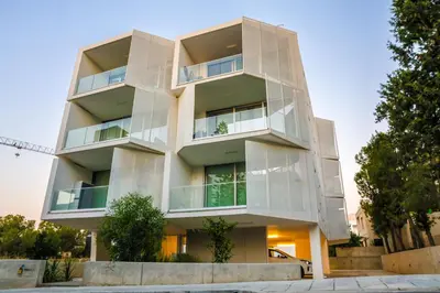 a white apartment building with glass balconies at Luxury Stay in Engomi