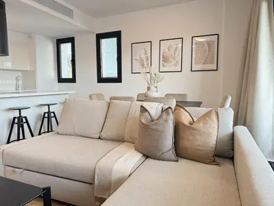 a living room with a couch and a kitchen at Phaedrus Living: White Hills Suites City View in Aglantzia