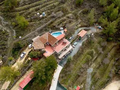 an aerial view of a house with a swimming pool at Fikardou Chalets in Phikardhou