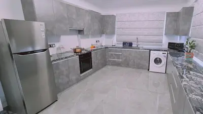 a kitchen with a refrigerator and a washing machine at STAY Centro Apartment in Larnaka