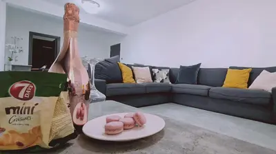 a bottle of milk and a plate of donuts in a living room at STAY Centro Apartment in Larnaka