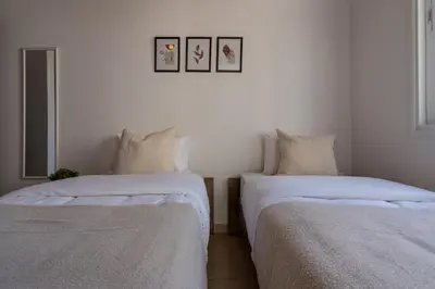 two beds sitting next to each other in a room at Laurel 2-Bedroom Apartment in Larnaca in Larnaka