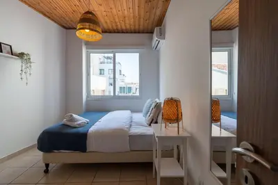 a bedroom with a bed and a window at Laurel 2-Bedroom Apartment in Larnaca in Larnaka
